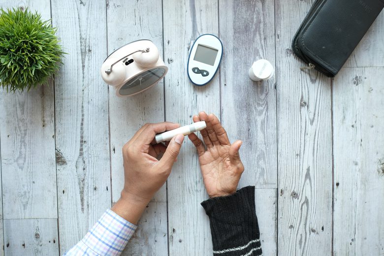 person measuring diabetic on table